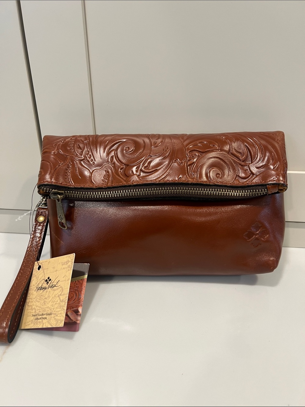 Patricia Nash Embossed Fold-Over Leather Wristlet in Cognac